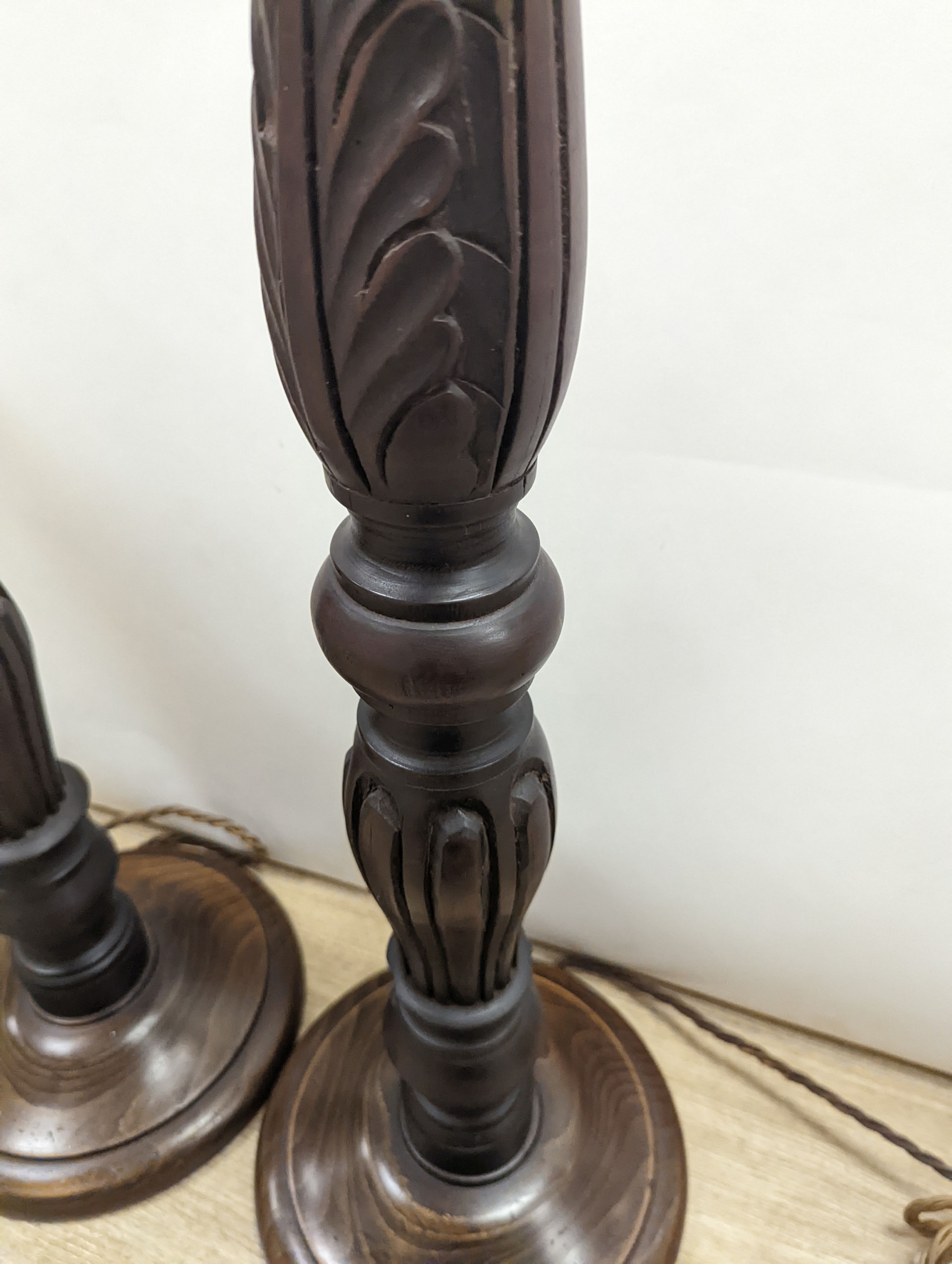 A pair of turned wood lamp bases, height 69cm excl. fitting